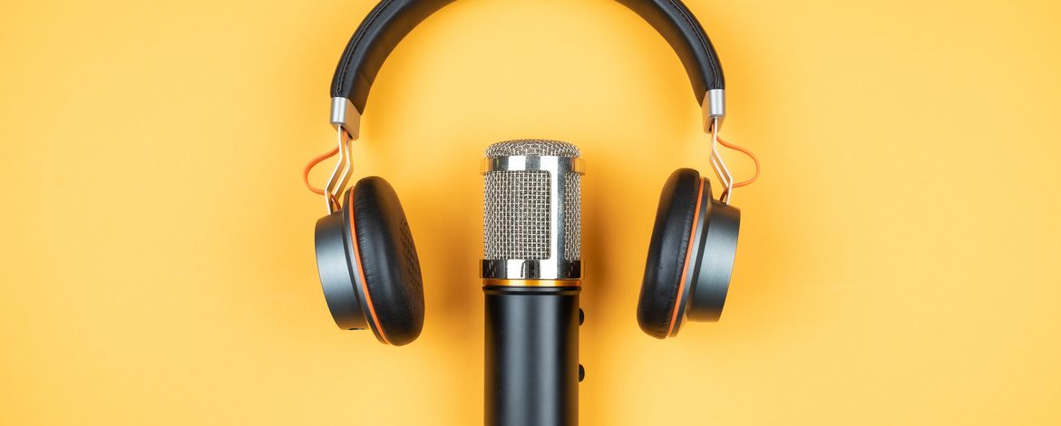 Microphone and headphones on yellow ground
